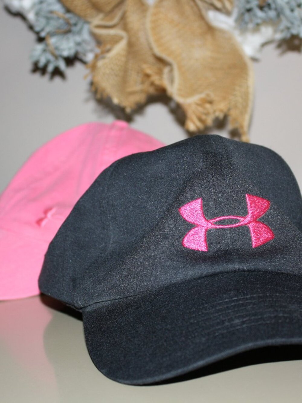 TWO (2) Under Armour, women's ball style hats.  1-PINK, 1-NAVY